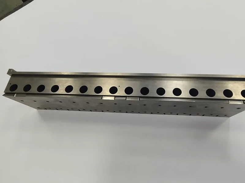 Long die holder with a ganged row of 17 wire-cut inserts, view 5