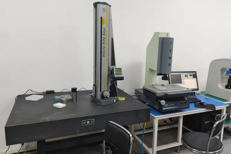 Inspection room with a TESA Micro-Hite 600 height gauge on a granite plate and a Rational VMS-3626 vision measuring system