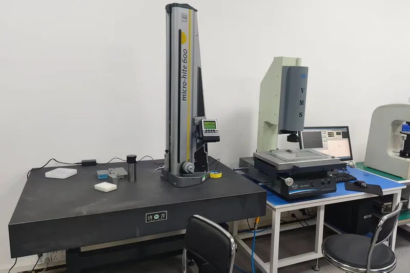 Inspection room with a TESA Micro-Hite 600 height gauge on a granite plate and a Rational VMS-3626 vision measuring system