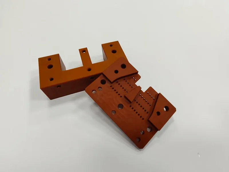 Machined laminate insulator bracket set, angled view showing machined steps