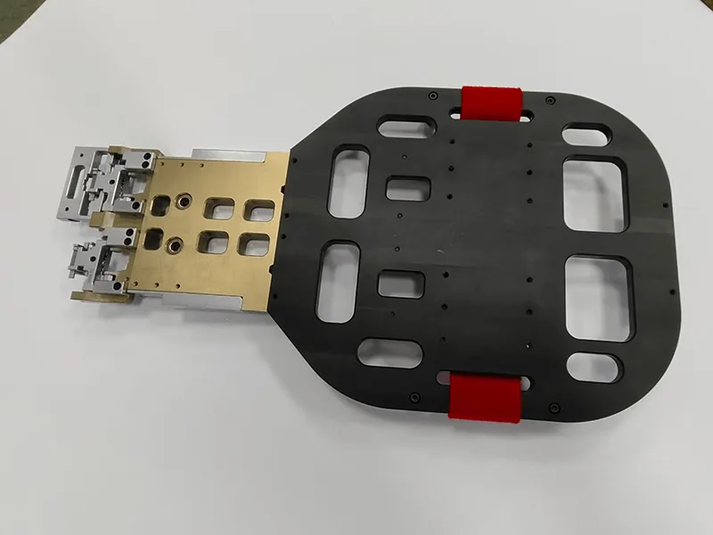 Robot end-of-arm gripper: pocketed base plate, red urethane pads, anodized manifold, stainless fingers, view 3
