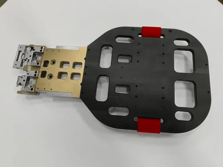 Robot end-of-arm gripper: pocketed base plate, red urethane pads, anodized manifold, stainless fingers, view 4