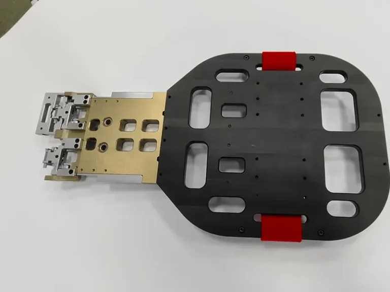 Robot end-of-arm gripper: pocketed base plate, red urethane pads, anodized manifold, stainless fingers, view 6