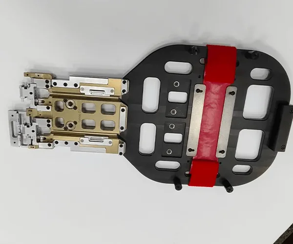Robot end-of-arm gripper: pocketed base plate, red urethane pads, anodized manifold, stainless fingers, view 7