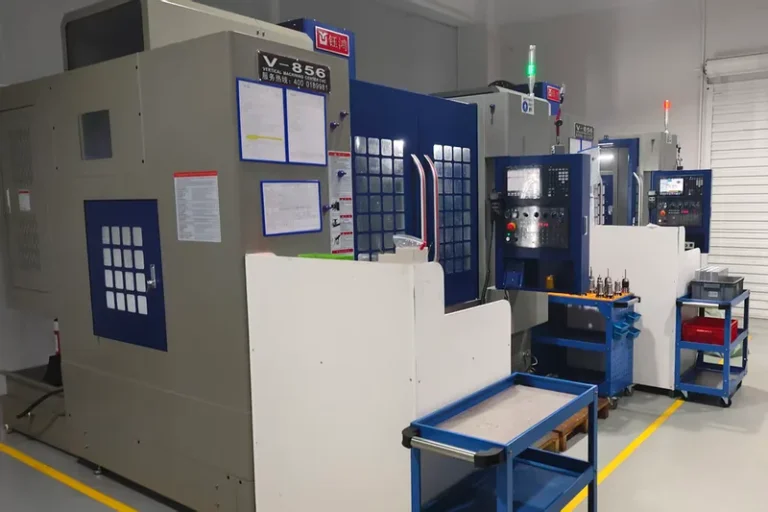 Three Yuhong V-856 vertical machining centres with tool carts on the shop floor